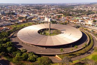 Vista aérea do terminal rodoviário de Londrina, com ônibus estacionados, edifícios e vias urbanas ao redor